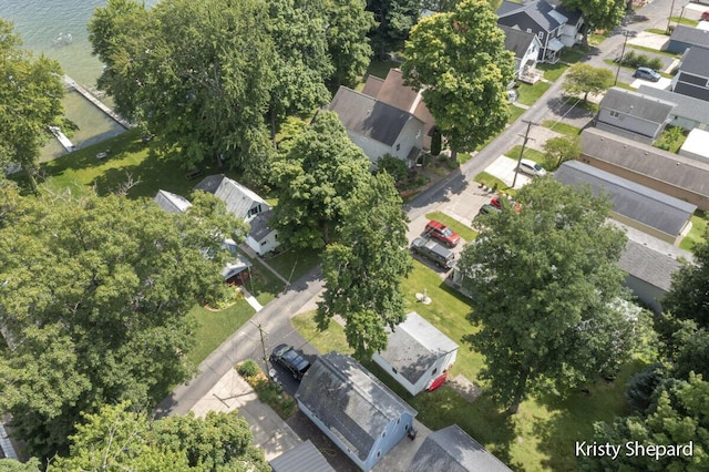 birds eye view of property with a residential view and a water view