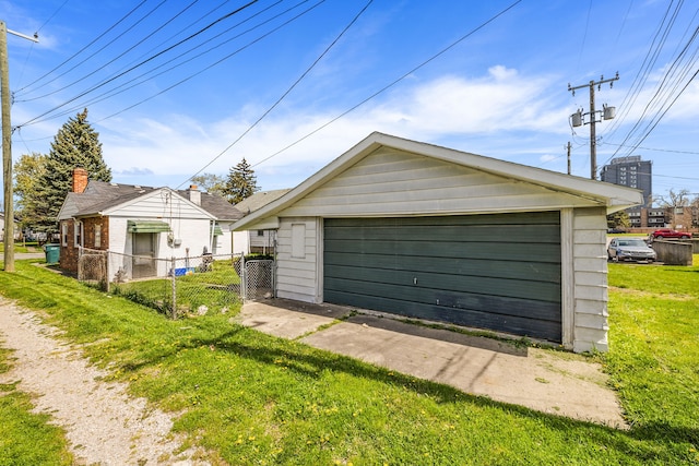 detached garage featuring fence