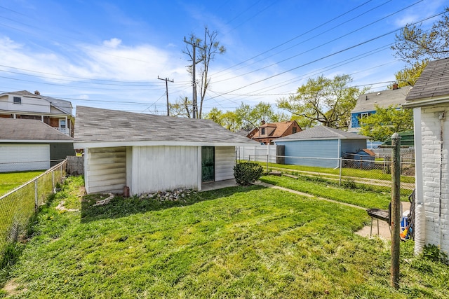 view of yard featuring an outdoor structure and a fenced backyard