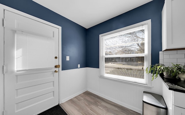 entryway with wainscoting and light wood-type flooring