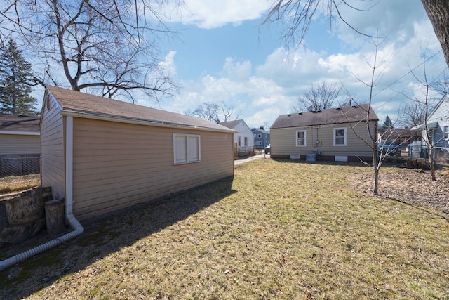 view of yard featuring an outdoor structure and fence