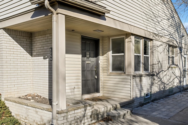 property entrance with brick siding