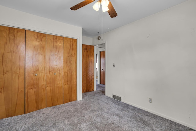 unfurnished bedroom featuring visible vents, baseboards, carpet, a closet, and a ceiling fan