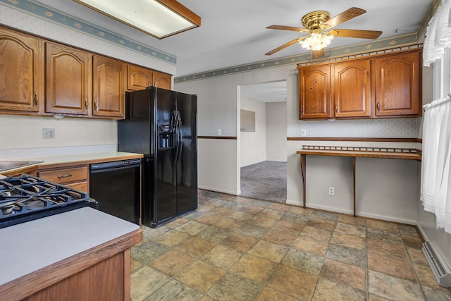 kitchen featuring black appliances, a baseboard heating unit, brown cabinetry, wallpapered walls, and baseboards