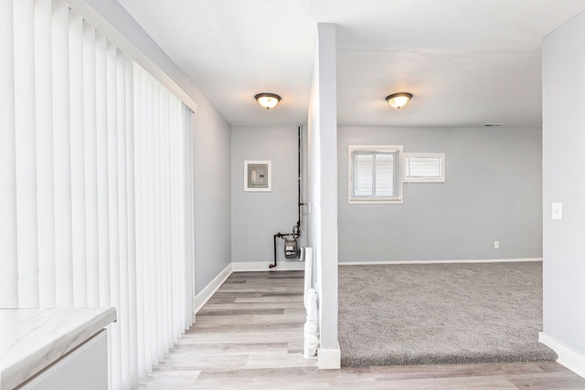 staircase featuring baseboards and wood finished floors