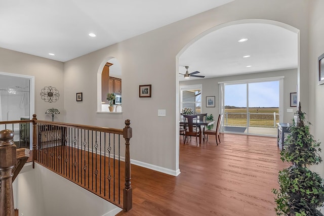 corridor with recessed lighting, baseboards, and light wood-style floors