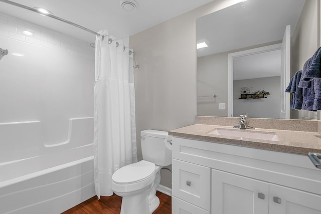 bathroom featuring vanity, toilet, wood finished floors, and shower / tub combo with curtain