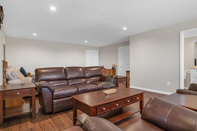 living area with recessed lighting, wood finished floors, and baseboards