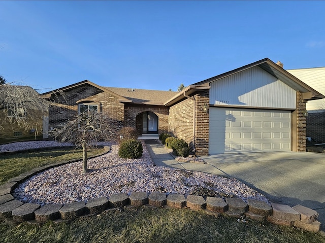 ranch-style house with brick siding, concrete driveway, and a garage