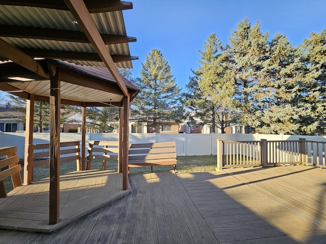 wooden deck featuring a fenced backyard