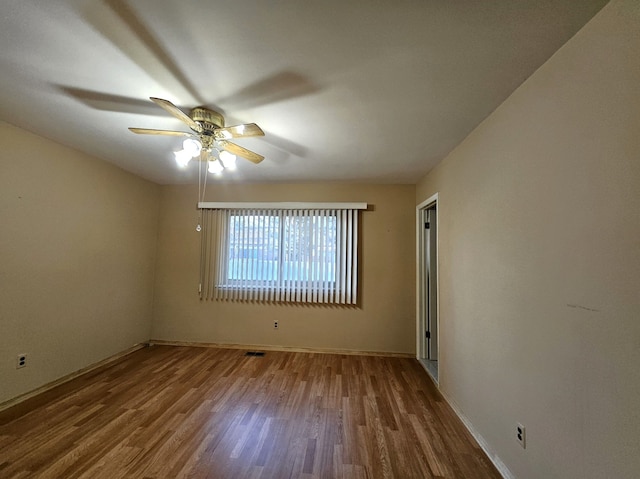 unfurnished room with ceiling fan and wood finished floors