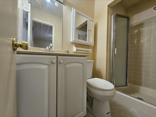 full bath with tile patterned flooring, toilet, vanity, and a stall shower