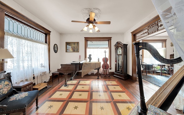 office space featuring ceiling fan, baseboards, and wood finished floors