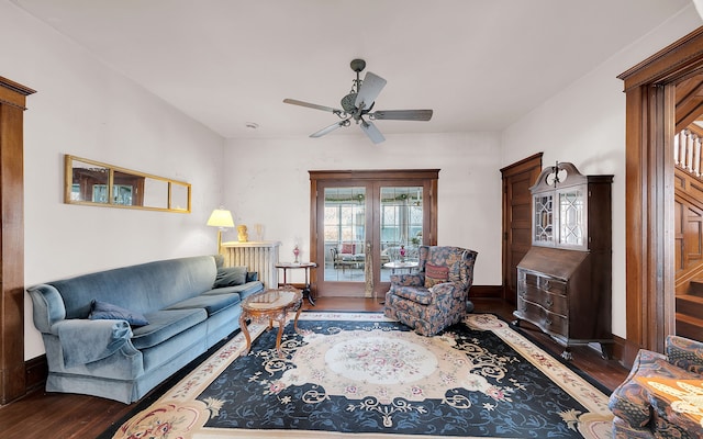 living room with baseboards, wood finished floors, and a ceiling fan