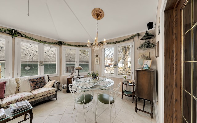 sunroom / solarium with a chandelier and vaulted ceiling