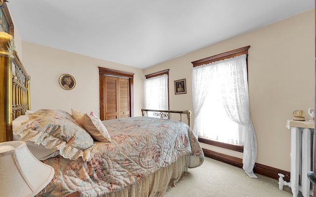 bedroom featuring baseboards, a closet, and carpet floors