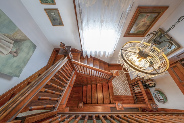 staircase with a chandelier