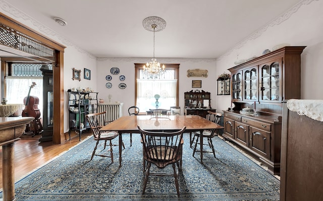 dining area featuring a notable chandelier and wood finished floors