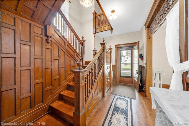 407 Westminister St, Marine City, MI 48039 - foyer with stairs, a chandelier, light wood-style flooring, wainscoting, and a decorative wall