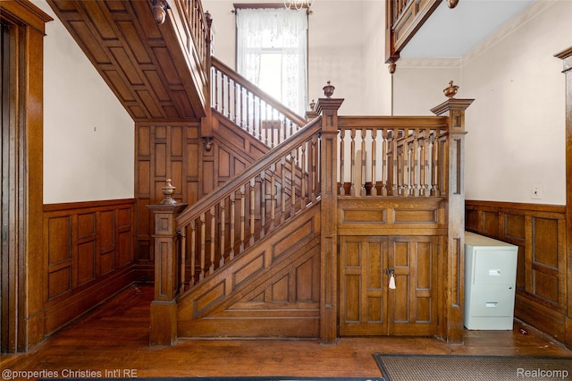 407 Westminister St, Marine City, MI 48039 - staircase with a wainscoted wall, wood-type flooring, a decorative wall, and wooden walls