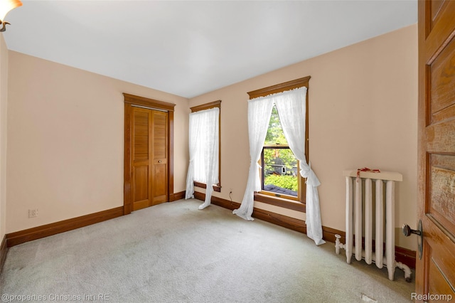 407 Westminister St, Marine City, MI 48039 - unfurnished room with radiator, light colored carpet, and baseboards