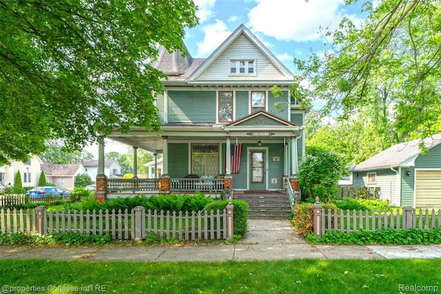 407 Westminister St, Marine City, MI 48039 - victorian home with a porch and a fenced front yard