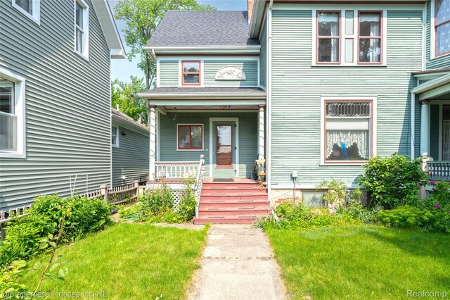 407 Westminister St, Marine City, MI 48039 - view of front of home with a porch, a front lawn, and a shingled roof
