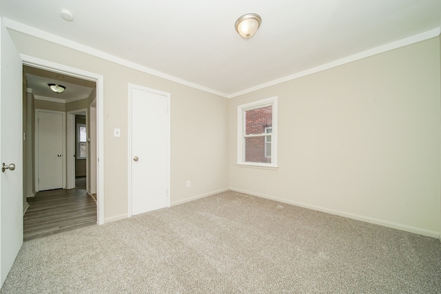 unfurnished room with carpet flooring, baseboards, and ornamental molding