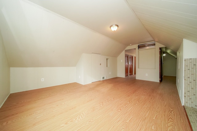 bonus room featuring vaulted ceiling, visible vents, and light wood-type flooring