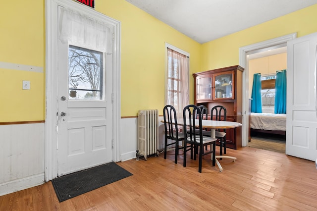 foyer with radiator and wood finished floors