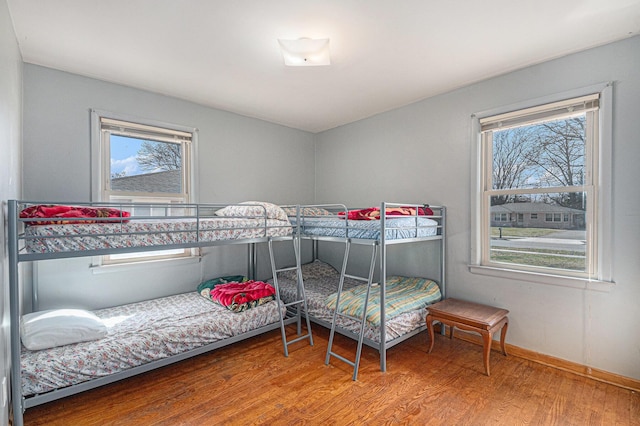 bedroom featuring wood finished floors and baseboards