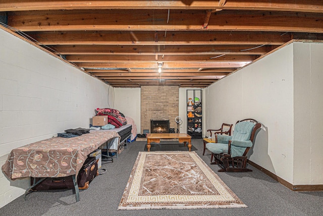 unfinished below grade area with carpet flooring and a fireplace