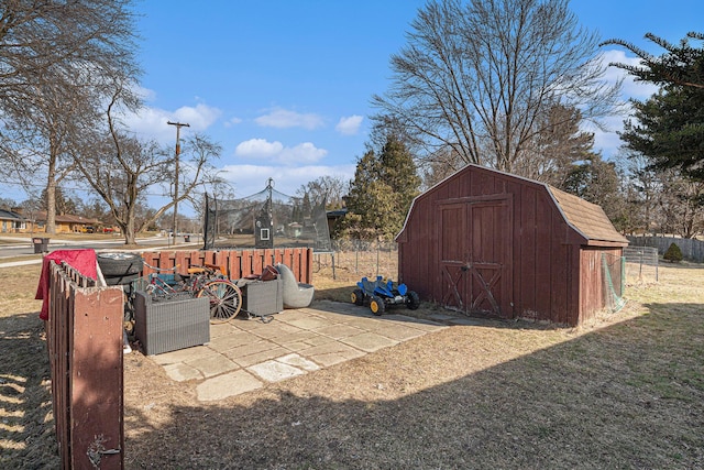 view of yard with an outbuilding, a storage shed, a trampoline, and fence