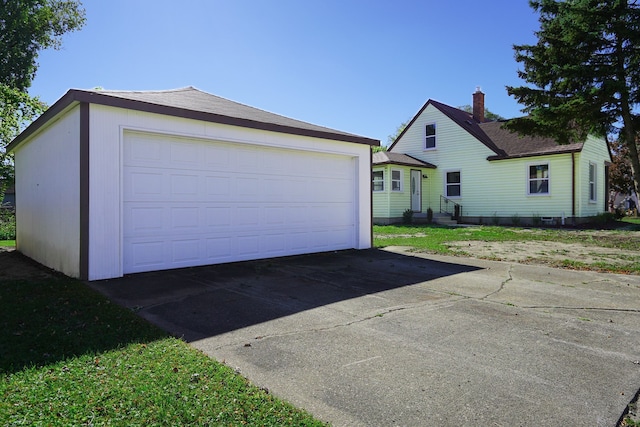 exterior space with a detached garage and entry steps