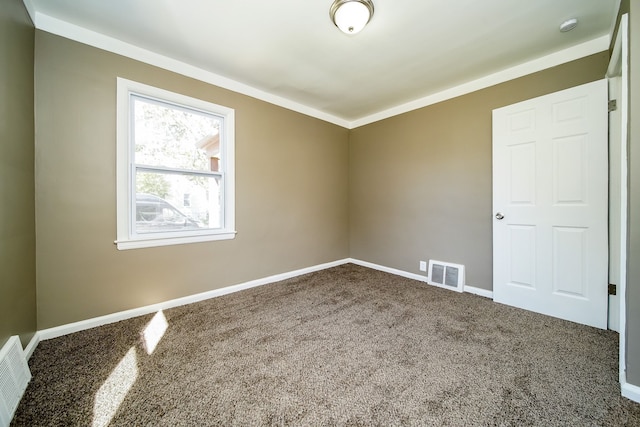 spare room featuring visible vents, baseboards, and carpet