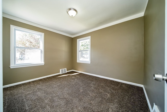 spare room with visible vents, baseboards, and carpet