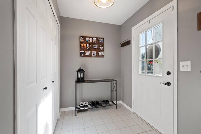 entryway featuring light tile patterned floors and baseboards