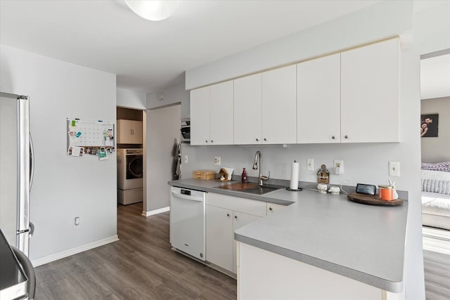 kitchen with wood finished floors, white dishwasher, freestanding refrigerator, a sink, and white cabinetry