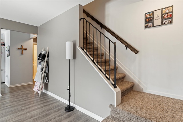 stairs featuring baseboards and wood finished floors