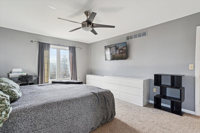 carpeted bedroom with baseboards, visible vents, and ceiling fan