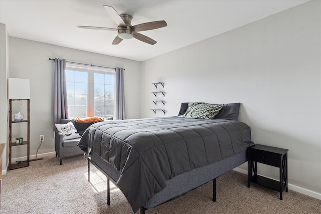 bedroom featuring a ceiling fan, light colored carpet, and baseboards