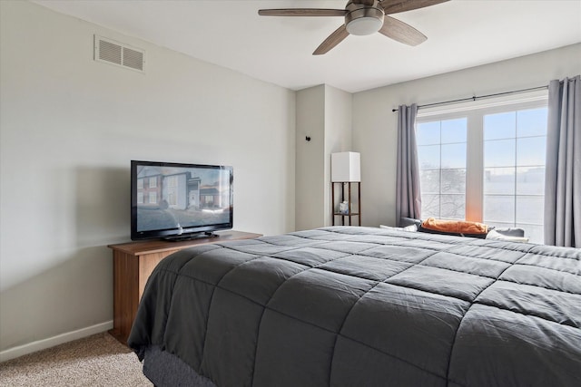 bedroom featuring visible vents, baseboards, ceiling fan, and carpet flooring