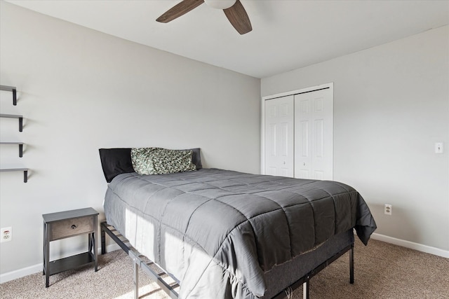 bedroom featuring ceiling fan, baseboards, a closet, and light carpet