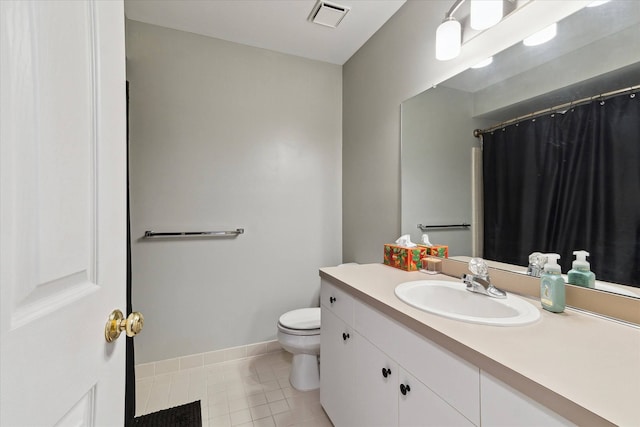 bathroom featuring vanity, baseboards, visible vents, tile patterned floors, and toilet