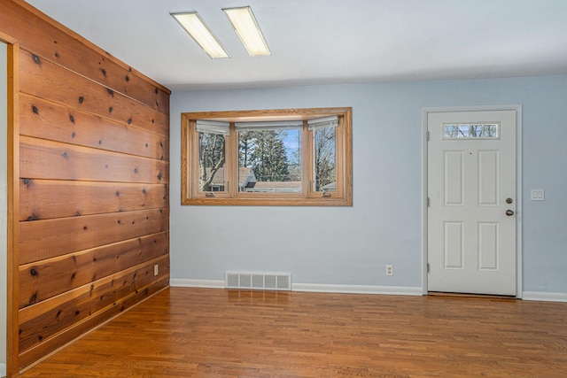 entrance foyer with visible vents, baseboards, and wood finished floors