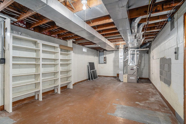 unfinished basement with electric panel and heating unit