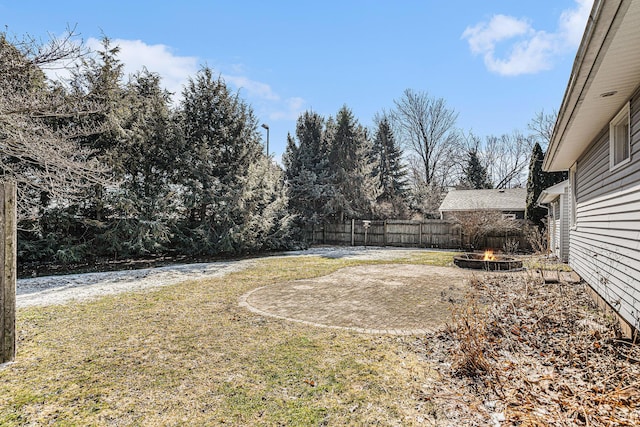 view of yard with a fire pit and fence