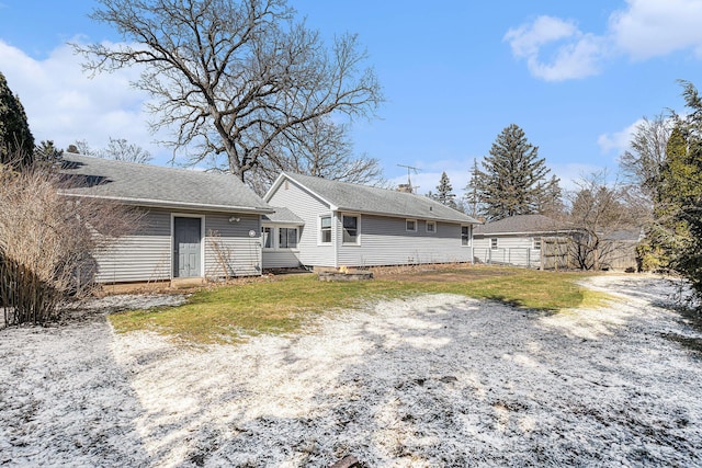 back of house featuring a chimney and fence