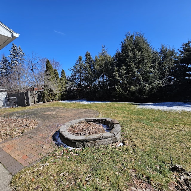 view of yard featuring a fire pit and fence