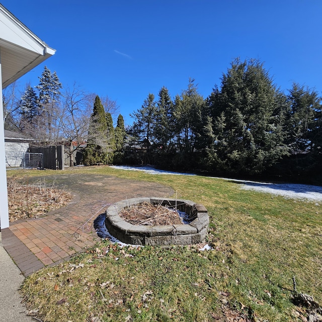 view of yard featuring a fire pit and fence